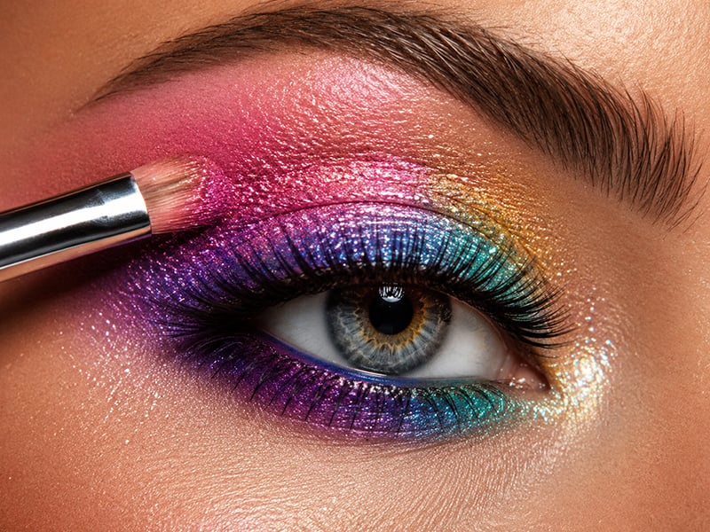 Makeup artist applying colorful advanced eyeshadow